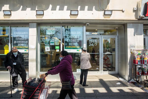 New Yorkers wait outside an advertisement store to cash stimulus checks.