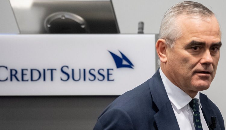 Credit Suisse reports a loss as regulators open an investigation.