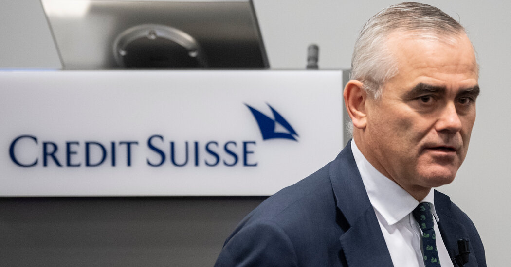 Credit Suisse reports a loss as regulators open an investigation.